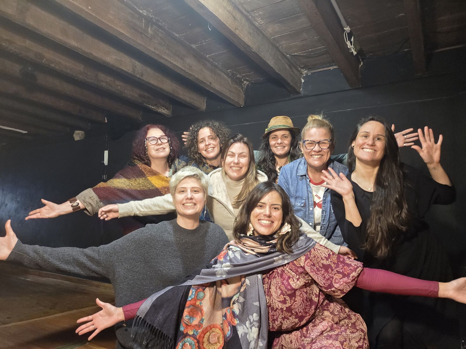 Grupo de mulheres sorrindo de braços abertos no fim de uma jornada no Porto